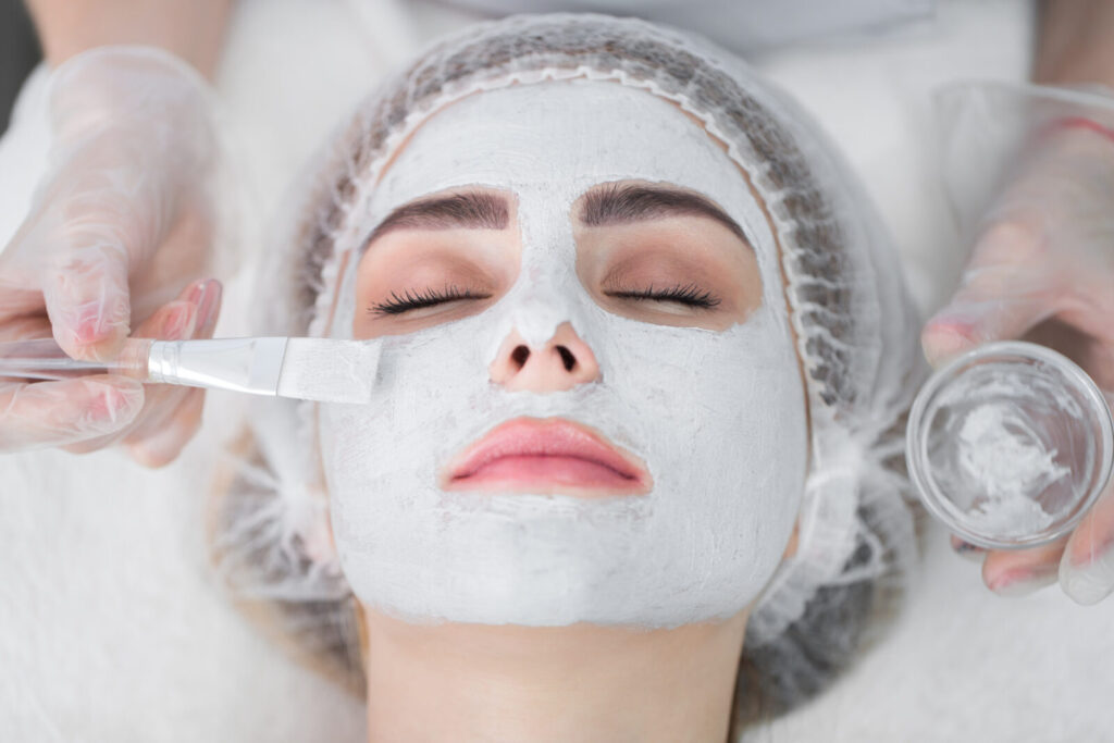 Face peeling mask, spa beauty treatment, skincare. Woman getting
